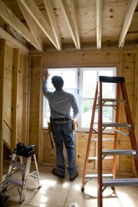 Contractor working on window in new home